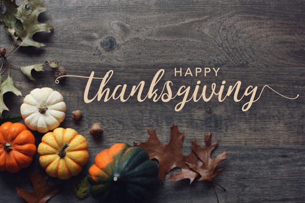 Happy Thanksgiving greeting text with colorful pumpkins, squash