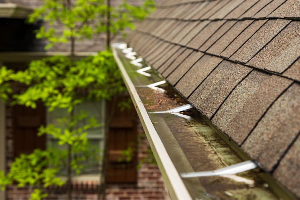 rain water overflowing in gutter.