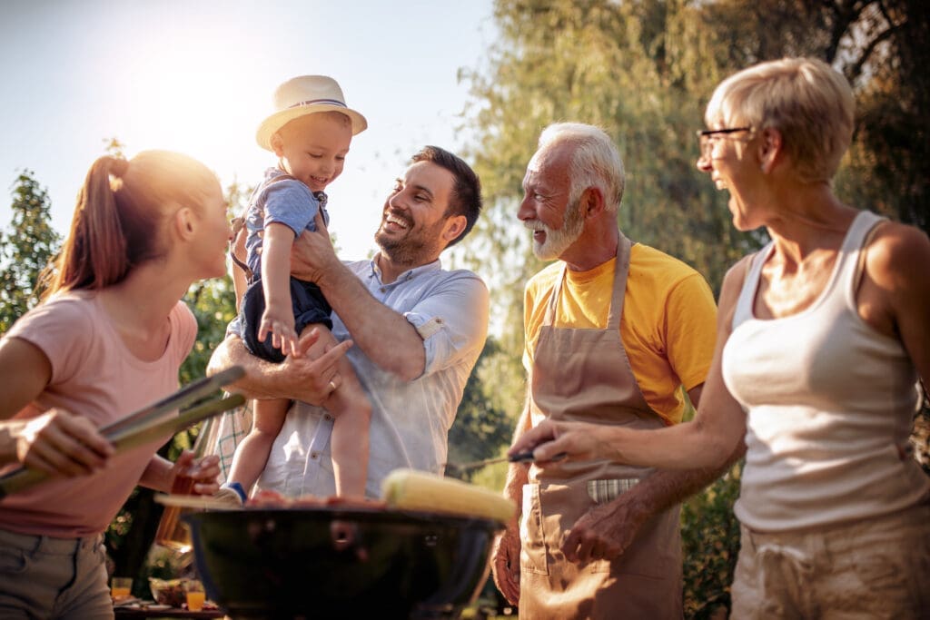 Barbecue time.Happy big family make barbecue in their garden.