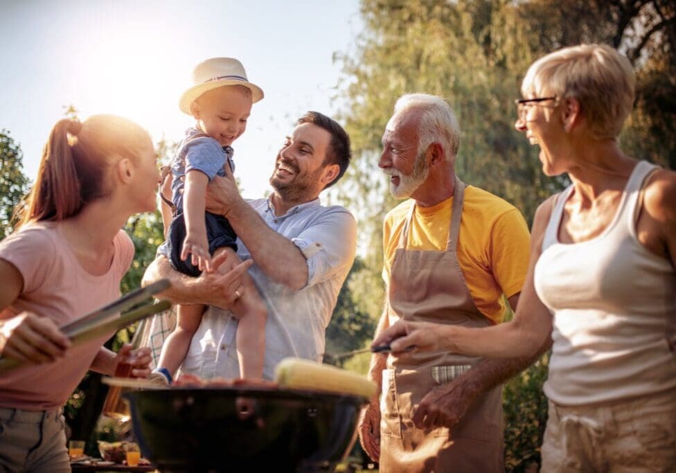 Barbecue time.Happy big family make barbecue in their garden.