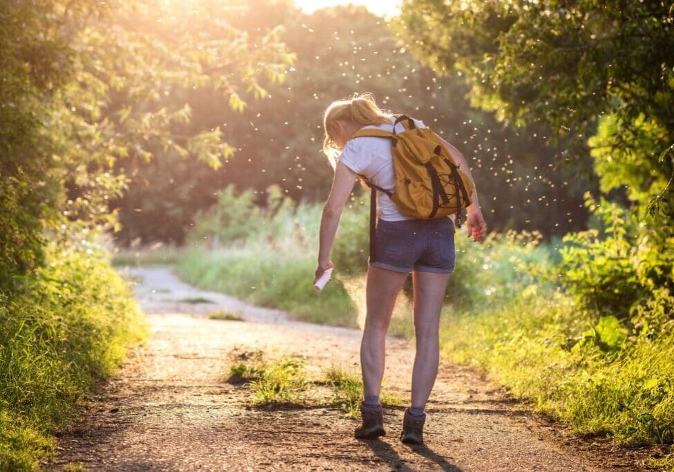 Woman applying insect repellent against mosquito and tick on her